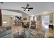 Open-concept living room with ceiling fan, seamlessly connected to the kitchen and dining area at 909 Autumn Glen Ct, Lake Wylie, SC 29710