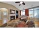 Cozy living room featuring a fireplace, ceiling fan, and comfortable seating at 909 Autumn Glen Ct, Lake Wylie, SC 29710