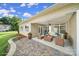 Covered patio with comfortable seating, a ceiling fan, and a decorative stone retaining wall at 909 Autumn Glen Ct, Lake Wylie, SC 29710