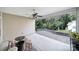 Outdoor covered patio with a ceiling fan, a view of the trees, and a stone retaining wall at 909 Autumn Glen Ct, Lake Wylie, SC 29710