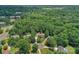 Aerial view of a charming home nestled among lush greenery in a peaceful neighborhood, ideal for families at 9423 Wood Ridge Dr, Charlotte, NC 28277