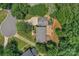 Aerial view of the home highlighting the spacious backyard with a playset and patio, surrounded by mature trees at 9423 Wood Ridge Dr, Charlotte, NC 28277