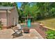 Backyard patio seating area with fire pit and play structure at 9423 Wood Ridge Dr, Charlotte, NC 28277