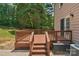 Elevated wood deck with stairs overlooking green backyard, adjacent to home's exterior at 9423 Wood Ridge Dr, Charlotte, NC 28277
