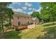 Spacious backyard featuring a wood deck, patio, playset, and well-maintained lawn, ideal for entertaining at 9423 Wood Ridge Dr, Charlotte, NC 28277