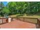 Expansive backyard with a wooden deck, a play structure, and lush greenery at 9423 Wood Ridge Dr, Charlotte, NC 28277