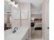 Bathroom view into a main bedroom featuring white vanity with a large mirror and modern fixtures at 9423 Wood Ridge Dr, Charlotte, NC 28277