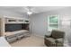 Bedroom showcasing a bunk bed, comfortable armchair, neutral carpet, and a window at 9423 Wood Ridge Dr, Charlotte, NC 28277