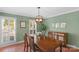 Dining room with shuttered windows and a charming wooden table set perfect for gatherings at 9423 Wood Ridge Dr, Charlotte, NC 28277