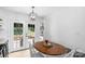 Bright dining area with french doors, and wood table with comfortable seating and natural light at 9423 Wood Ridge Dr, Charlotte, NC 28277