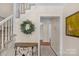 Welcoming foyer with staircase, table and rug, offering a warm invitation into the home at 9423 Wood Ridge Dr, Charlotte, NC 28277