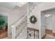 Inviting entryway with staircase, wreath, and neutral decor creates a warm welcome at 9423 Wood Ridge Dr, Charlotte, NC 28277