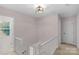 Upstairs hallway with carpet, access to an outside view through a window, and several doorways at 9423 Wood Ridge Dr, Charlotte, NC 28277