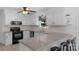 Bright kitchen featuring white cabinets, modern appliances, and a large countertop with bar stool seating at 9423 Wood Ridge Dr, Charlotte, NC 28277