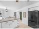Bright kitchen featuring granite countertops, white cabinetry, stainless steel appliances, and an adjacent breakfast nook at 9423 Wood Ridge Dr, Charlotte, NC 28277