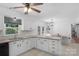 Open kitchen featuring granite countertops, white cabinetry, stainless steel appliances, and an adjacent breakfast nook at 9423 Wood Ridge Dr, Charlotte, NC 28277