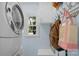 Convenient laundry room with modern washer and dryer, storage cabinets, and a bright window at 9423 Wood Ridge Dr, Charlotte, NC 28277