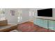 Living room featuring built-in cabinets, hardwood floors, shutters, and bright natural light at 9423 Wood Ridge Dr, Charlotte, NC 28277