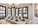 Bright dining room featuring a modern chandelier, large windows, and a long table with white chairs at 0000 Woodhill Cove Ln # 5, Denver, NC 28037