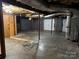 Unfinished basement featuring concrete floors, block walls, exposed ceiling, and double doors at 103 Sycamore Rd, Salisbury, NC 28147