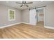 Bedroom with wood floor, ceiling fan, window and sliding barn door to closet at 103 Sycamore Rd, Salisbury, NC 28147