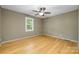 Neutral bedroom featuring hardwood floors, a ceiling fan, and bright window at 103 Sycamore Rd, Salisbury, NC 28147