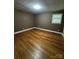Empty bedroom featuring hardwood floors, neutral walls, and a bright window at 103 Sycamore Rd, Salisbury, NC 28147