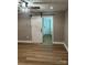 Bedroom featuring a sliding barn door to an adjacent room and hardwood floors at 103 Sycamore Rd, Salisbury, NC 28147