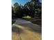 Long concrete driveway leading to a home with lush green surroundings, set back from the street at 103 Sycamore Rd, Salisbury, NC 28147
