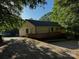 Cozy single-story home with a wooden deck surrounded by mature trees, perfect for outdoor relaxation at 103 Sycamore Rd, Salisbury, NC 28147
