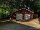 Two-car garage featuring white doors, set amidst a wooded area, offering ample parking and storage at 103 Sycamore Rd, Salisbury, NC 28147
