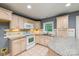 Traditional kitchen with granite counters, tile floor, cream colored cabinets, and a window at 103 Sycamore Rd, Salisbury, NC 28147