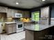 Well-lit kitchen featuring ample counter space, modern appliances, and a bright window at 103 Sycamore Rd, Salisbury, NC 28147