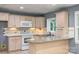 A spacious kitchen area featuring granite countertops, wood cabinets, and a tile backsplash at 103 Sycamore Rd, Salisbury, NC 28147