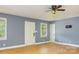A spacious living room area with hardwood flooring, natural light, and multiple doors at 103 Sycamore Rd, Salisbury, NC 28147