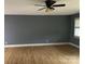 Minimalist living room with wood-look floors, neutral walls, a ceiling fan and a window at 103 Sycamore Rd, Salisbury, NC 28147