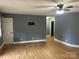Spacious living room with wood-look floors, neutral walls, and a ceiling fan at 103 Sycamore Rd, Salisbury, NC 28147