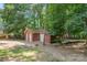 Exterior of large red outbuilding with multi-car garage, mossy roof and lots of storage at 103 Sycamore Rd, Salisbury, NC 28147