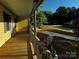 Inviting covered front porch with wood flooring and railings, offering a relaxing outdoor space at 103 Sycamore Rd, Salisbury, NC 28147
