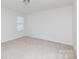 Spacious bedroom featuring neutral carpet, a large window, and abundant natural light at 1148 Bannockburn Ave, Rock Hill, SC 29732