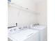 White Whirlpool washer and dryer in well-lit laundry room with wire shelving at 1148 Bannockburn Ave, Rock Hill, SC 29732