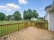 Spacious wooden deck overlooking a lush green backyard, perfect for outdoor dining and relaxation in a serene setting at 1148 Stallings Rd, Matthews, NC 28104