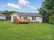 Expansive backyard featuring a large grassy area and a wooden deck, perfect for outdoor activities and enjoying nature at 1148 Stallings Rd, Matthews, NC 28104