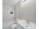 Bright bathroom featuring a tub with shower, tiled walls, and a white vanity at 1148 Stallings Rd, Matthews, NC 28104