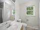 Well-lit bathroom with large mirror, window, and tile flooring at 1148 Stallings Rd, Matthews, NC 28104