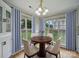 Charming breakfast nook bathed in natural light, complemented by a stylish chandelier and scenic outdoor views at 1148 Stallings Rd, Matthews, NC 28104