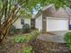 Charming home with a brick accent, lush landscaping, and an inviting entryway, set in a peaceful neighborhood at 1148 Stallings Rd, Matthews, NC 28104