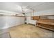 Spacious garage with workbench, storage shelves and large overhead door at 1148 Stallings Rd, Matthews, NC 28104