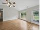 Bright living room with vaulted ceilings, a ceiling fan, and a view to the deck at 1148 Stallings Rd, Matthews, NC 28104