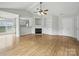 Spacious living room featuring a cozy fireplace and open access to the kitchen, perfect for modern living and entertaining at 1148 Stallings Rd, Matthews, NC 28104